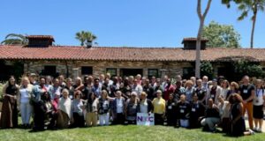 The 2023 class of Project LEAD graduates take a group photo outside on a sunny day