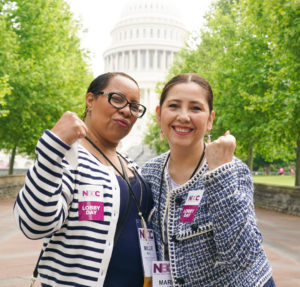 Two women raise fists in front of US Capitol